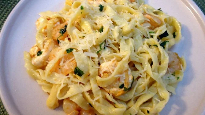 Krevety s těstovinami na talíři, omáčka s parmezánem a bylinkami