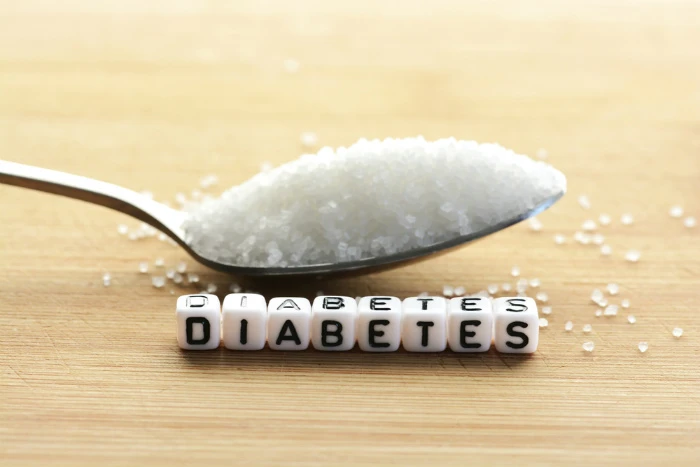 Lžíce cukru nad kostkami s nápisem DIABETES