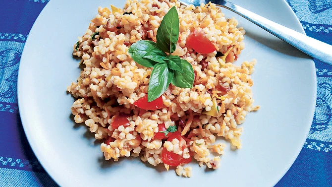 Bulgur se zeleninou na talíři s bazalkou